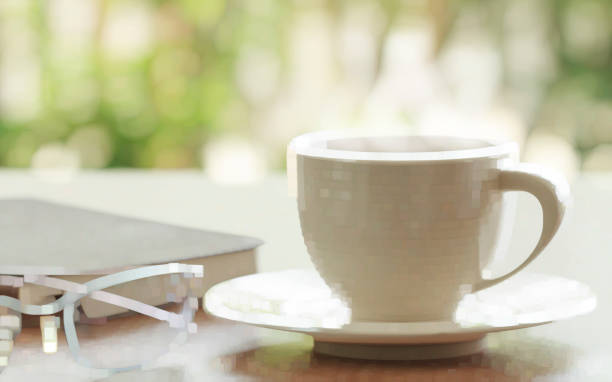 istock Cup Of Coffee And Eyeglasses With Book On Table. 695549082