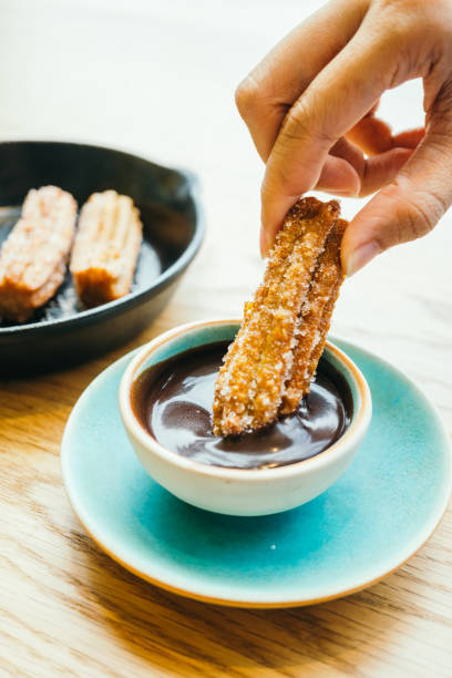 istock Sweet fried Churros donut with chocolate sauce 695555624