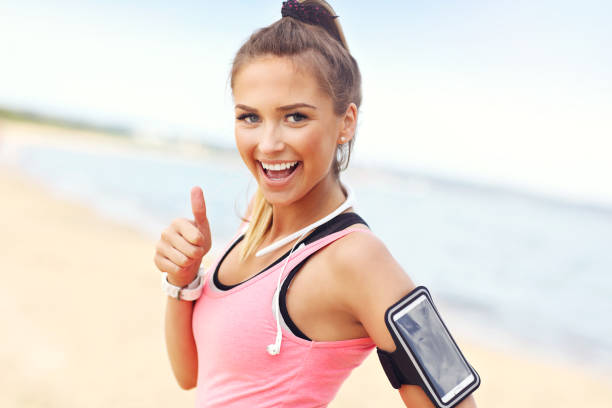 istock Woman jogging on the beach 695558240