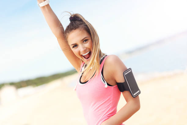 istock Woman jogging on the beach 695558264