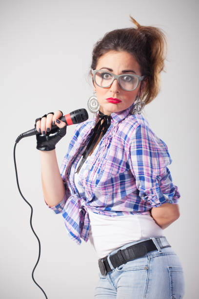 istock Confused nerdy female singer 695558278