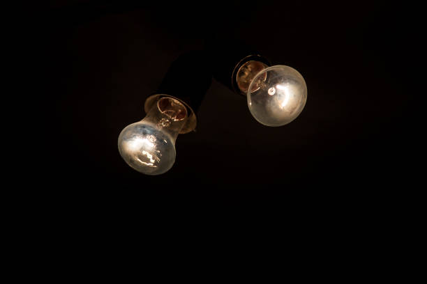 istock Two retro light bulb in the dark . New ideas 695561410