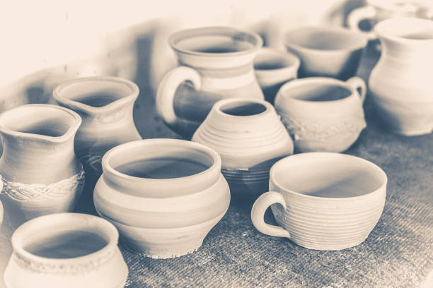 istock Old vintage photo. Many Clay pots on the table 695576434