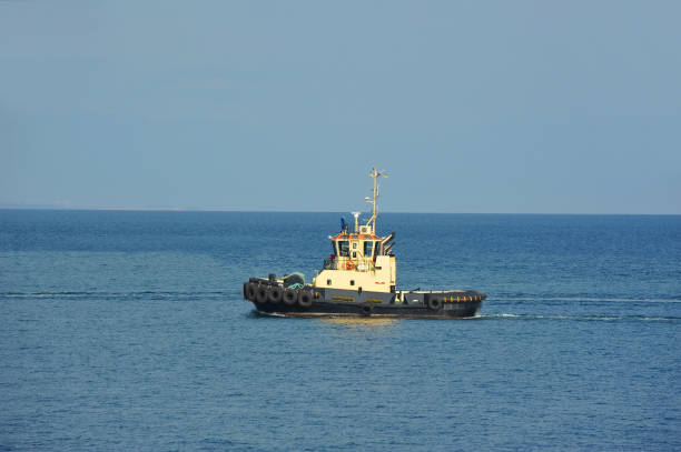 istock Tugboat in harbor quayside 695577620