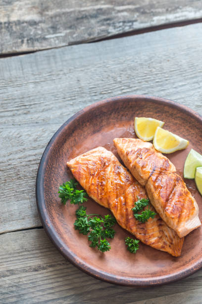 istock Roasted salmon steak with fresh parsley 695580318