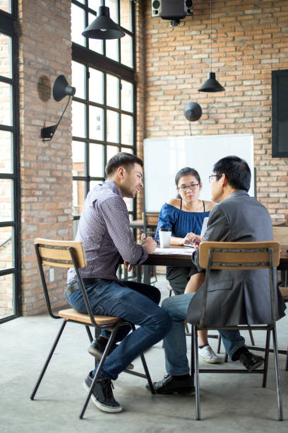 istock Business Team Discussing Strategy in Cafe 695580474