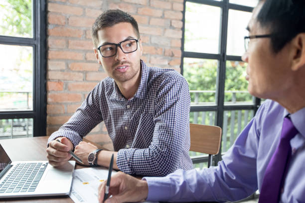 istock Two Serious Coworkers Talking in Loft Cafe 695580752