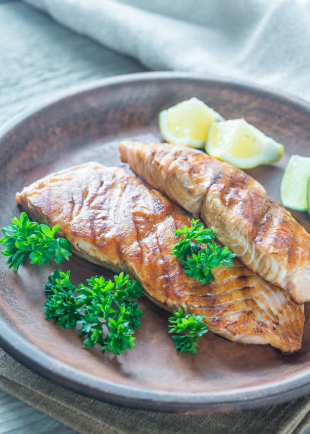 istock Roasted salmon steak with fresh parsley 695581048