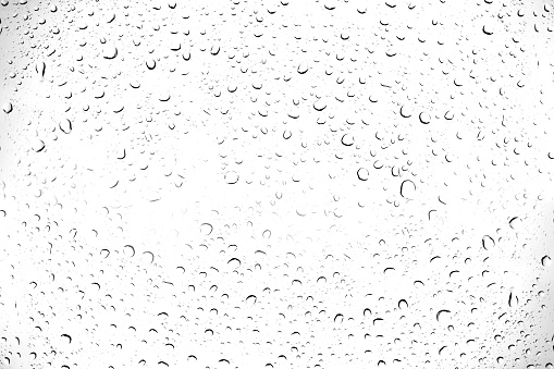 Water drops on white transparent glass window after rain for background.