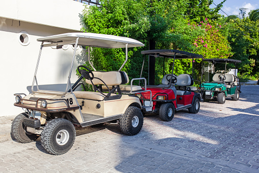 Golf carts in a raw outside, nobody. Mexico, Cancun, Isla Mujeres