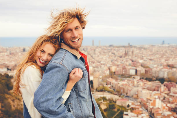 istock Cheerful couple embracing against cityscape 695596612