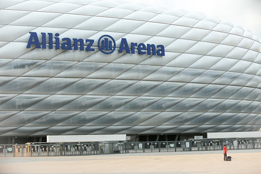 MUNICH, GERMANY - MAY 9, 2017 : A young man taking a selfie in front of the Allianz Arena football stadium in Munich, Germany. The Allianz Arena is home football stadium for FC Bayern Munich.