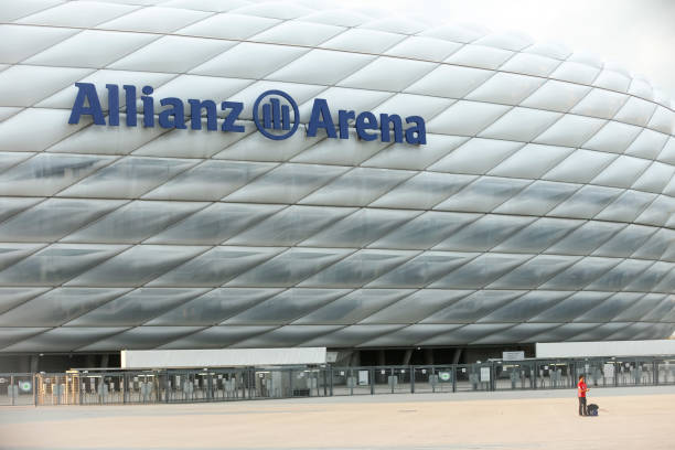 Allianz Arena in Munich MUNICH, GERMANY - MAY 9, 2017 : A young man taking a selfie in front of the Allianz Arena football stadium in Munich, Germany. The Allianz Arena is home football stadium for FC Bayern Munich. allianz arena stock pictures, royalty-free photos & images
