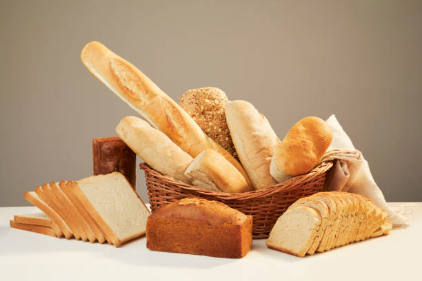 Basket with assorted baking products Basket with assorted baking products in studio shot. loaf of bread stock pictures, royalty-free photos & images