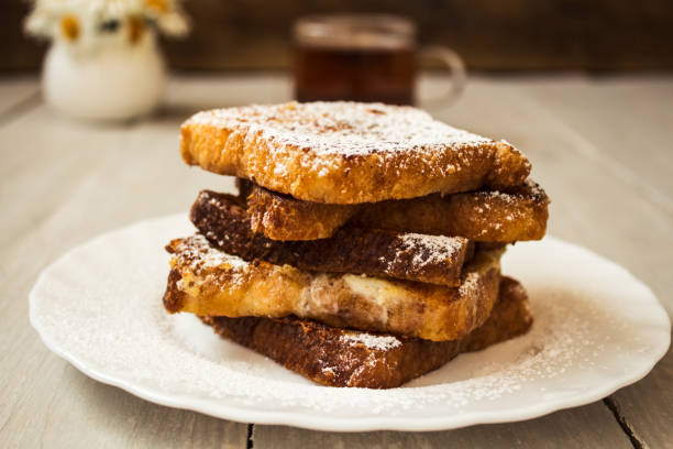 istock french toast with tea on wooden background 695603674