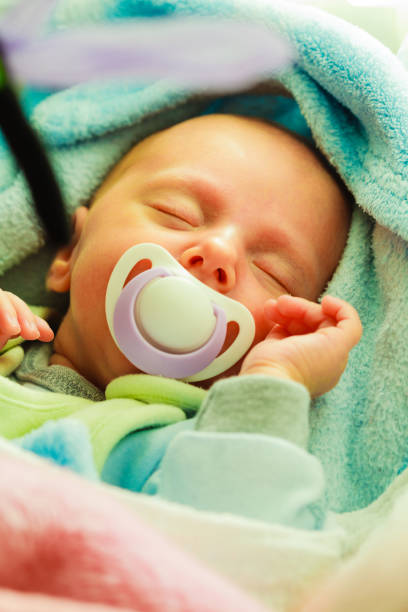 istock Little newborn baby sleeping with dummy 695612096