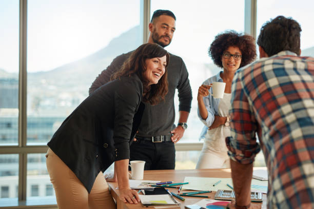 Group of multi ethnic people during business meeting Young and creative team discussing ideas in board room. Group of multi ethnic people during business meeting. casual clothing stock pictures, royalty-free photos & images