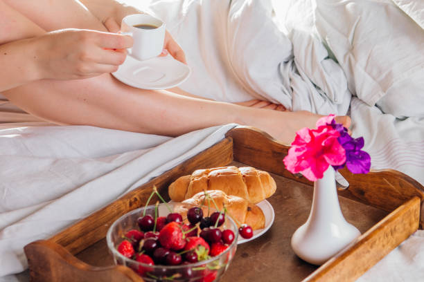 istock Woman having breakfast in bed 695616524