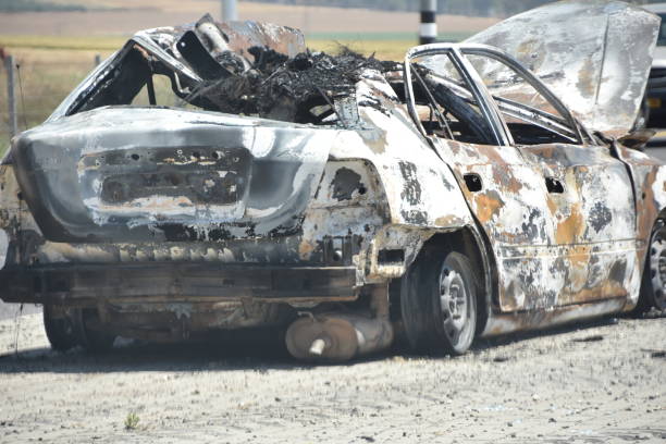 istock burnt car on the road 695621850