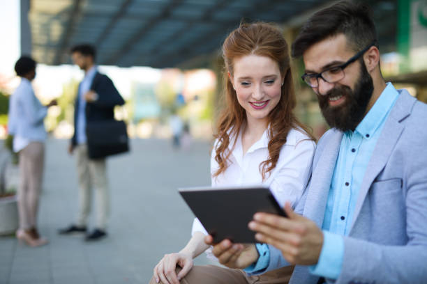 istock Business people planning a meeting using digital tablet outdoors 695621936