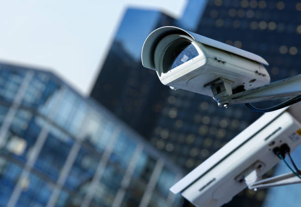 istock cctv security camera in a city with blury business building on background 695637450