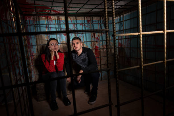 istock Two Halloween victims in a cage 695637512