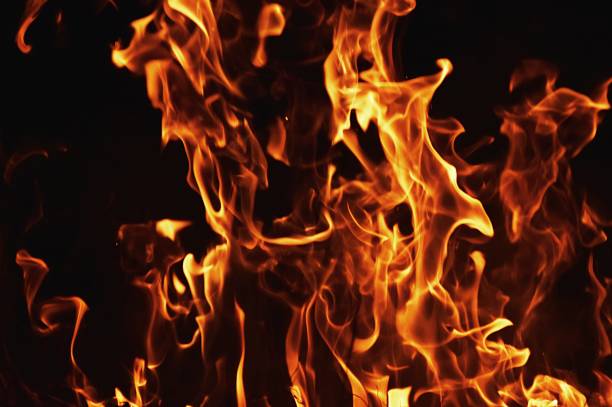 istock flame of fire in darkness 695637878