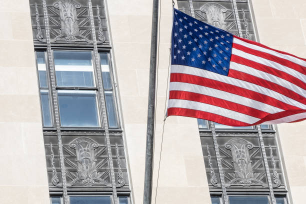 istock American flag flying outside an American courthouse 695638088
