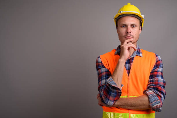 istock Studio shot of man construction worker against gray background 695641216