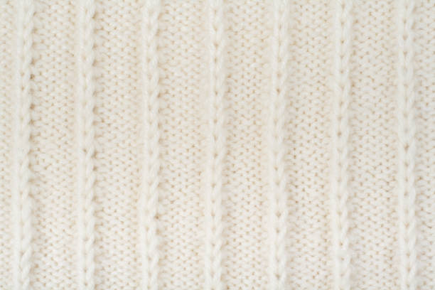 istock Sweater or scarf fabric texture large knitting. Knitted jersey background with a relief pattern. Wool hand- machine, handmade 695646210