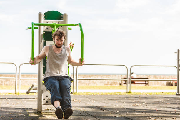 istock Active man exercising on chest press outdoor. 695659852
