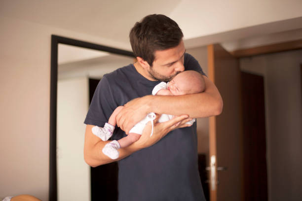 Newborn baby in father's arms