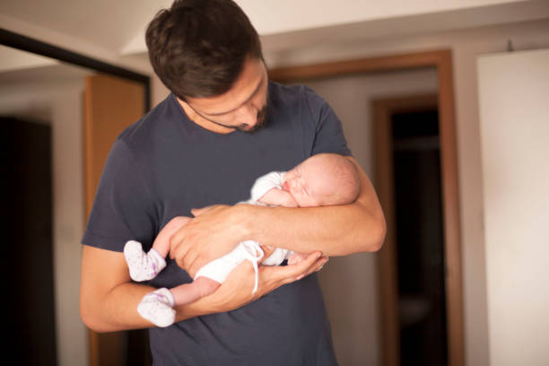 istock Newborn baby in father's arms 695667416