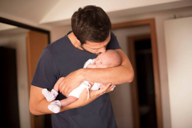 istock Newborn baby in father's arms 695667422