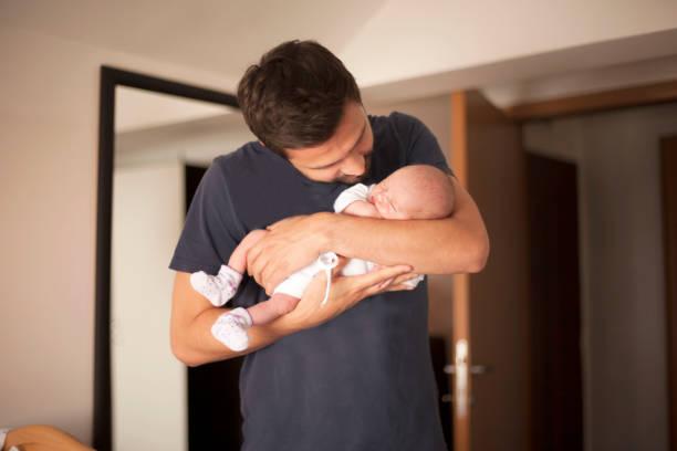 istock Newborn baby in father's arms 695667428
