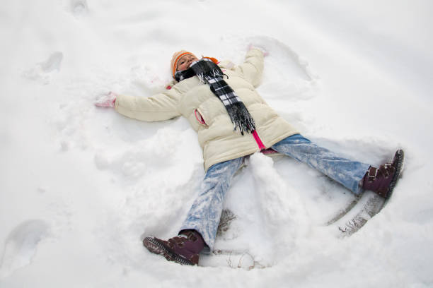 istock Young girl making a snow angel 695671542