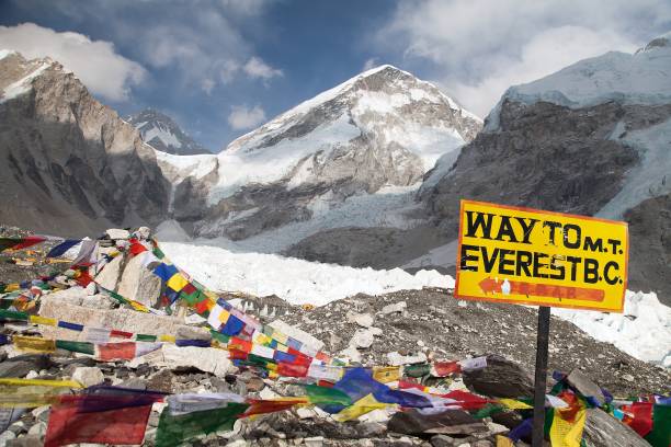 signpost way to m.t. everest b.c. signpost way to mount everest b.c., Khumbu glacier and prayer flags, Everest area, Nepal base camp photos stock pictures, royalty-free photos & images