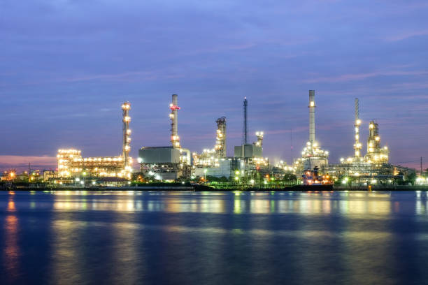 istock river side oil refinery industry plant along twilight morning 695679024