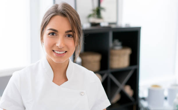 istock Happy beautician working at the spa 695685928