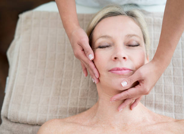 istock Woman getting a facial at the spa 695686064