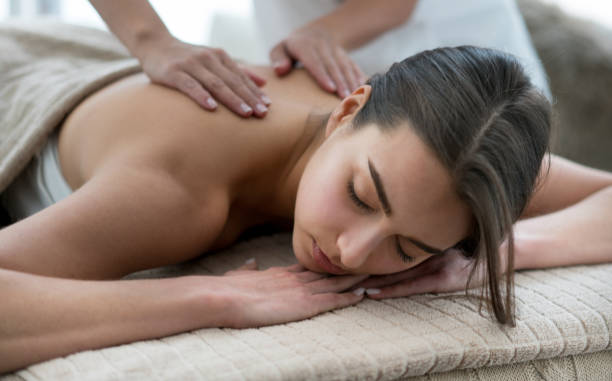 istock Beautiful woman getting a back massage at the spa 695686108