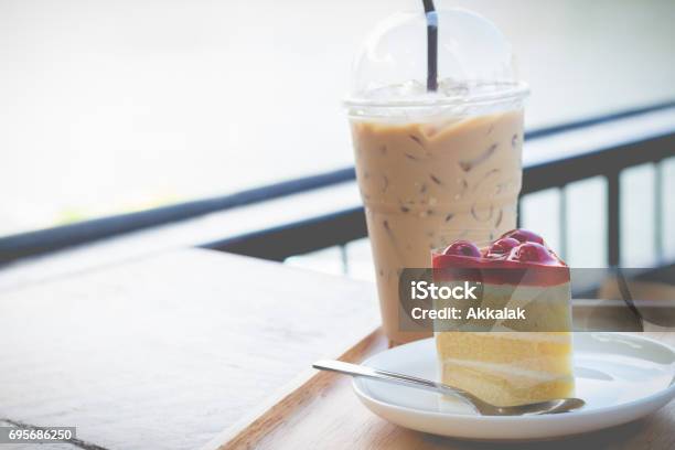 Sponge Cake With Cherry Syrup Peace Of Cherry Cake Serve With Iced Coffee In Cozy Outdoor Cafe Stock Photo - Download Image Now