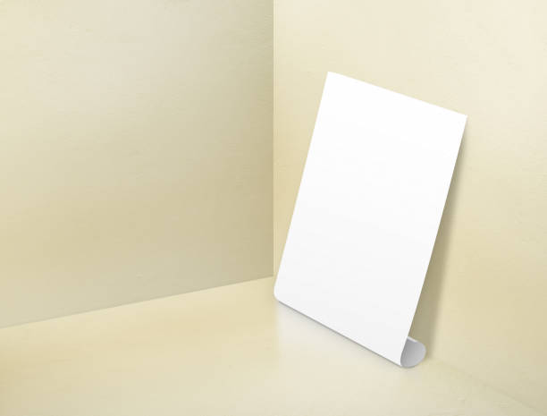 istock Blank white rolling poster at corner painted pastel yellow color studio room background,Mock up template for display or montage of design or text ,Online marketing media tool 695686472