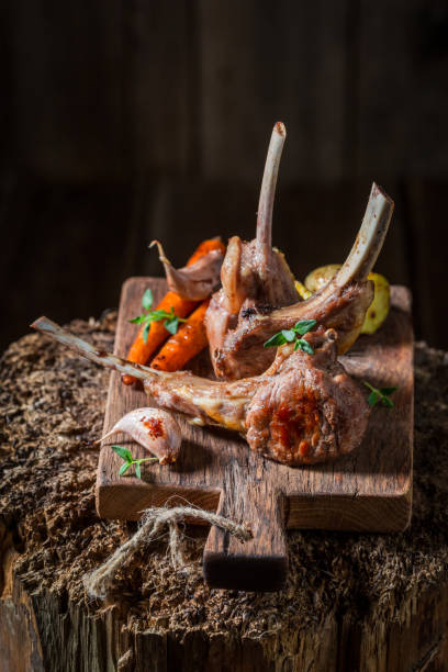 istock Delicious roasted lamb ribs on old wooden plank 695686666