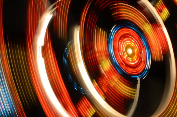 istock Carnival ride spinning in the night 695689648