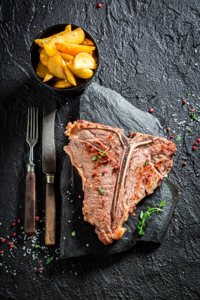 istock Closeup of homemade tbone steak and chips 695689736