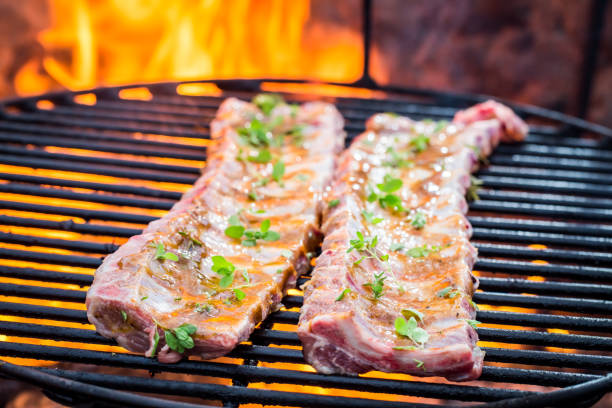 istock Tasty ribs with thyme and spices on grill 695693188