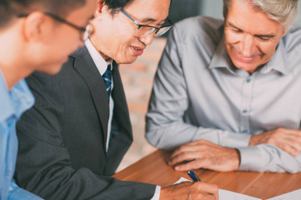 istock Experienced Asian man arranging merger deal_tone 695695280