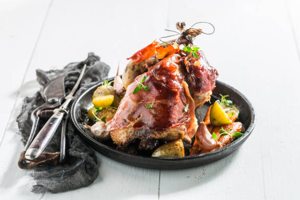 istock Homemade pheasant with bacon and spices on white background 695698842