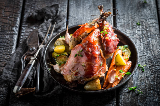 istock Fresh pheasant with bacon and spices on dark background 695698986
